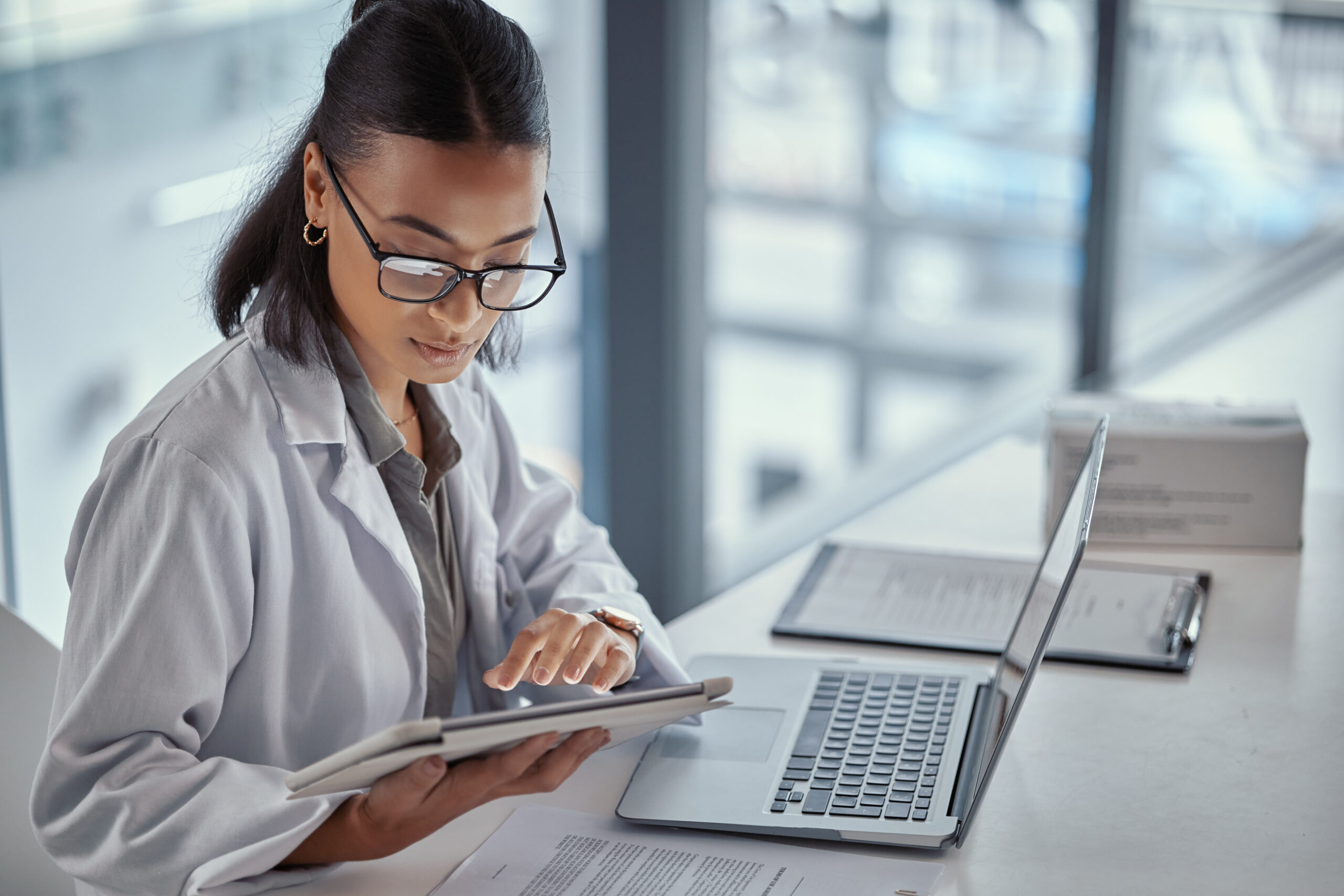 Shot of a young female doctor using a digital tablet at work